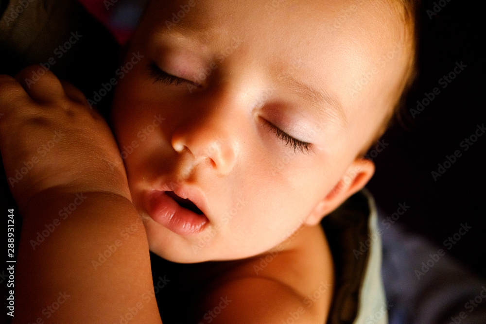 Close-up portrait of the face of a sleeping baby resting on his arm. Close-up portrait of the face of a sleeping baby resting on his arm.