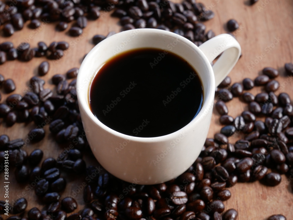 cup of coffee with beans on wooden background cup of coffee with beans on wooden background