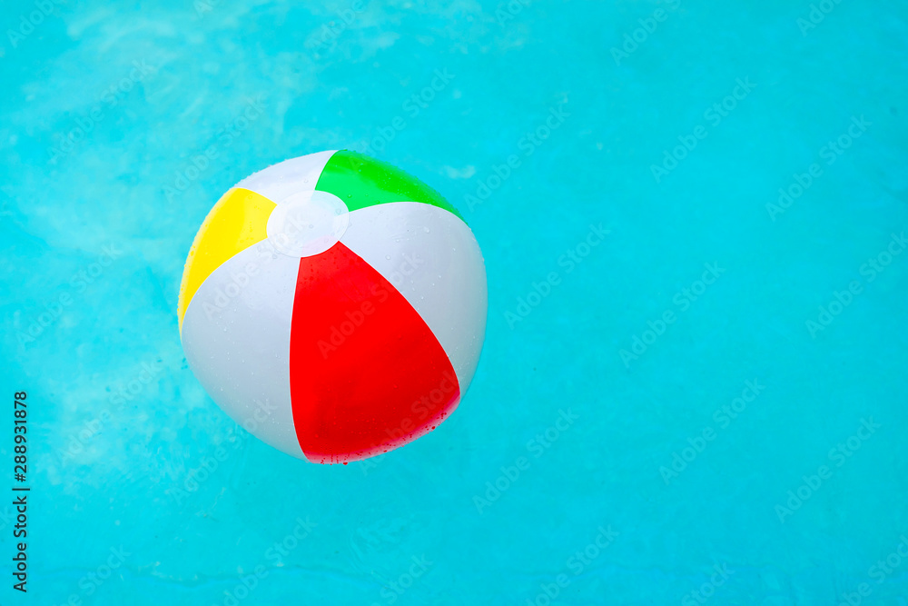 Colorful beach ball in the swimming pool as concept for summertime Stock Photo Adobe Stock