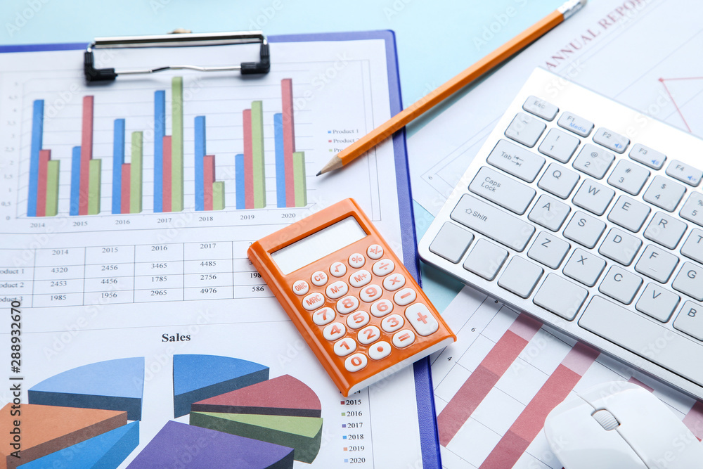Financial papers with keyboard, calculator and pencil Financial papers with keyboard, calculator and pencil