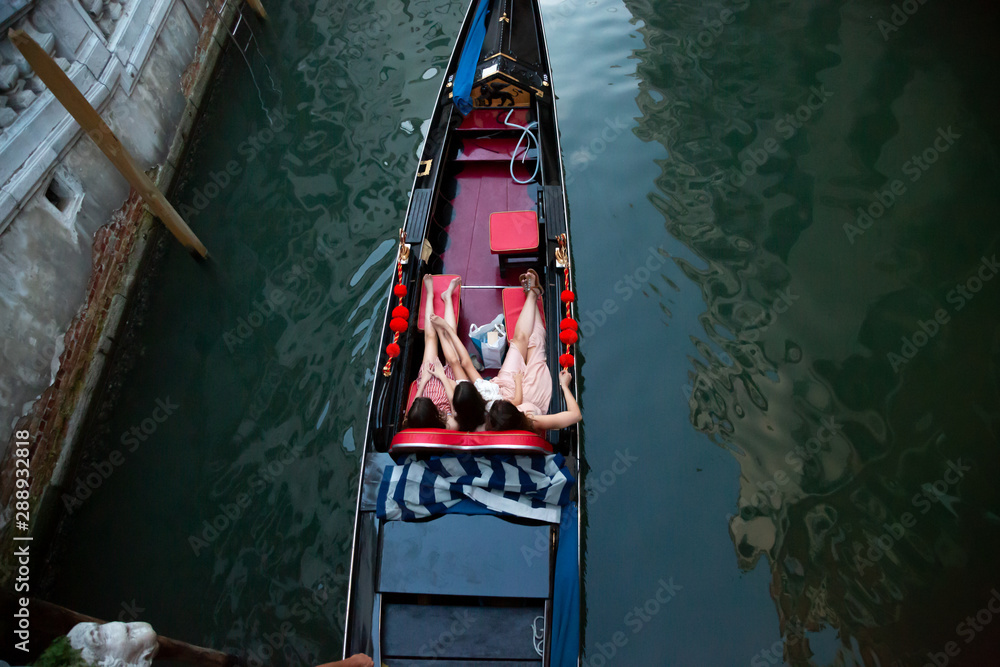 Tourists riding a gondola in Venice, Italy.
