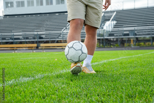 boy in soccer or football stadium isolated with white ball. 