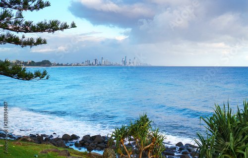 Fototapeta Naklejka Na Ścianę i Meble -  Stunning view of the Gold Coast skyline and surfing beach, visible from the park at Burleigh Heads, Queensland, Australia. 