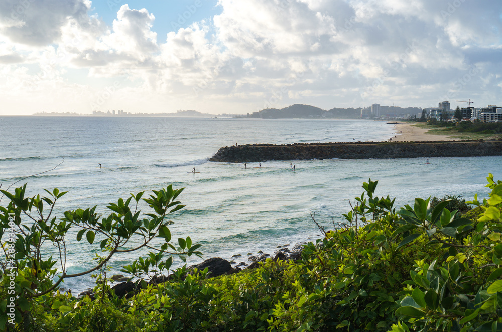 Stunning view of the Pacific Ocean and surfers catching waves in Tallebudgera Creek, visible from the Burleigh Head National Park on Gold Coast, Australia.