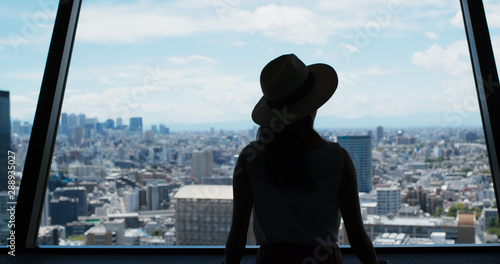 Photography Woman enjoy the view of Tokyo city at observation deck
