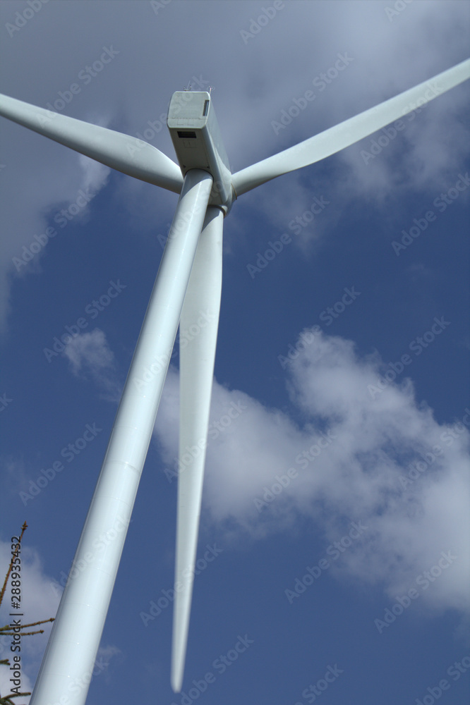 Wind turbine on a blue sky with white clouds Wind turbine on a blue sky with white clouds