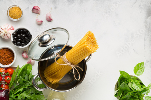 Cooking Italian Spaghetti Pasta. Raw materials for cooking on a light background