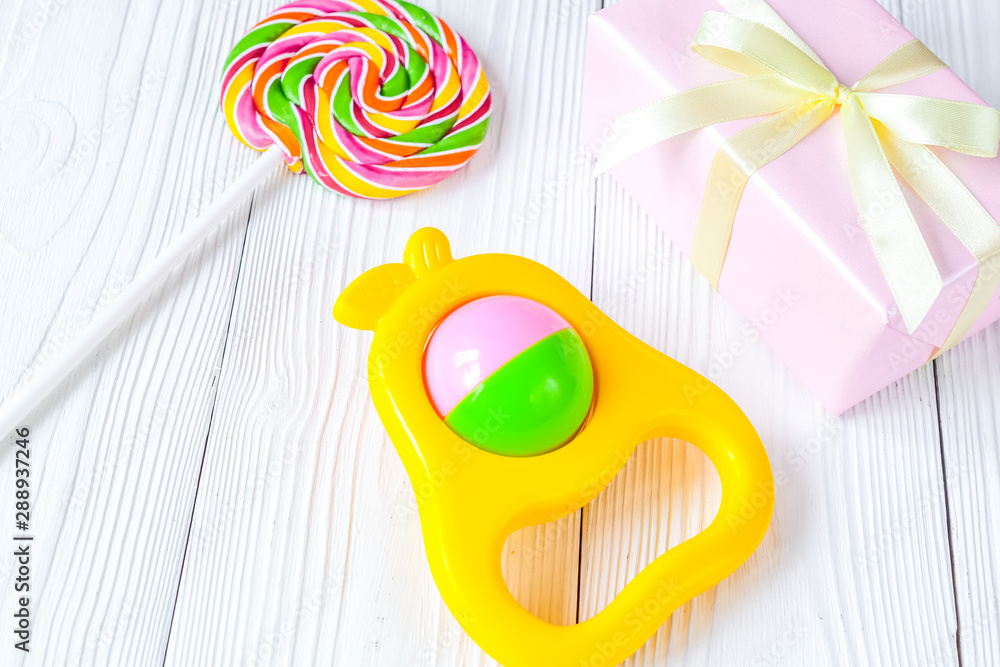 rainbow candy and gift box on wooden background