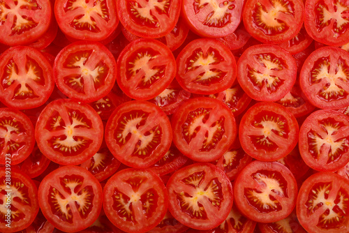 Sliced tomato background. Top view. © Nikolay
