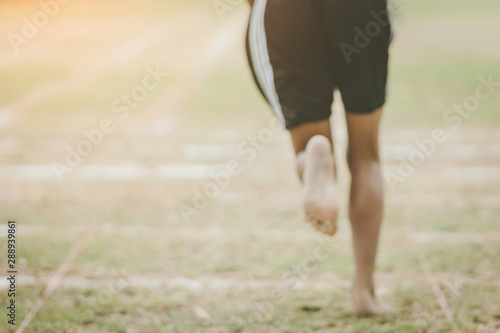 Blur image of Students fitness training for sprinting on an athletic track in school.