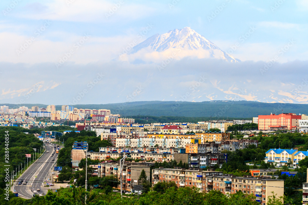  View of the city Petropavlovsk-Kamchatsky on background of Koryaksky Volcano. Russian Far East, Kamchatka Peninsula.