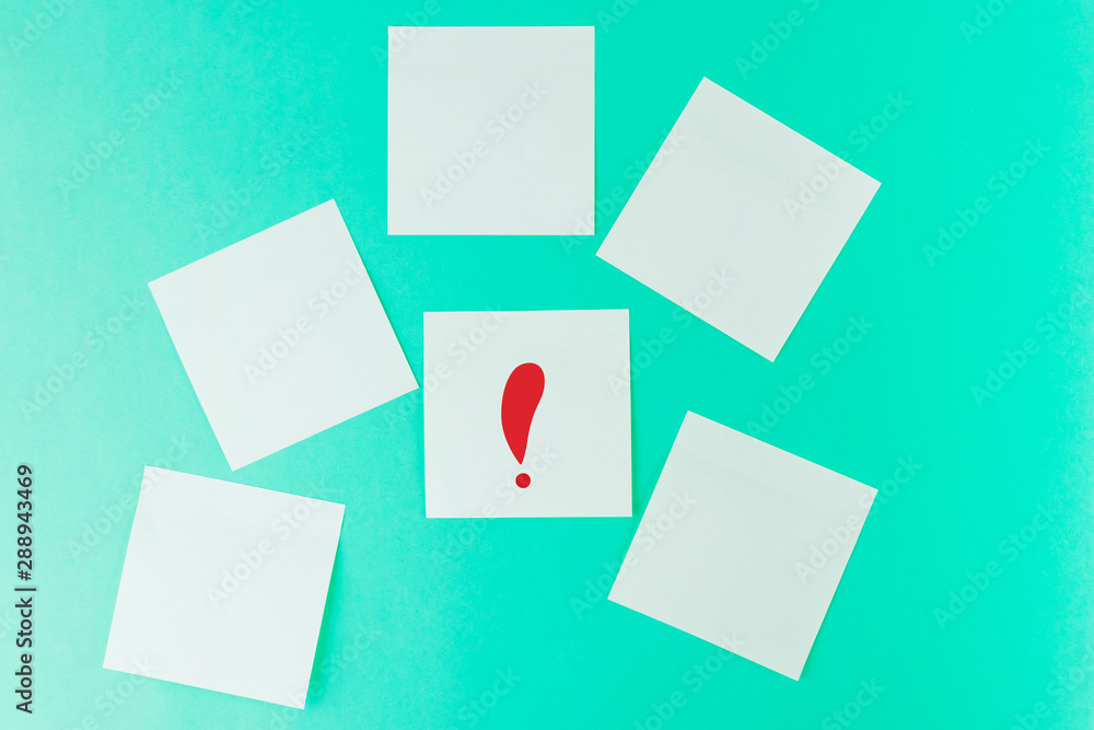Stickers on a pastel green background. On one sticker is a red exclamation mark. Place for text, notes. Minimalism. Stickers on a pastel green background. On one sticker is a red exclamation mark. Place for text, notes. Minimalism.