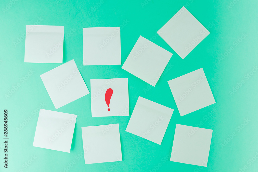 Stickers on a pastel green background. On one sticker is a red exclamation mark. Place for text, notes. Minimalism. Stickers on a pastel green background. On one sticker is a red exclamation mark. Place for text, notes. Minimalism.