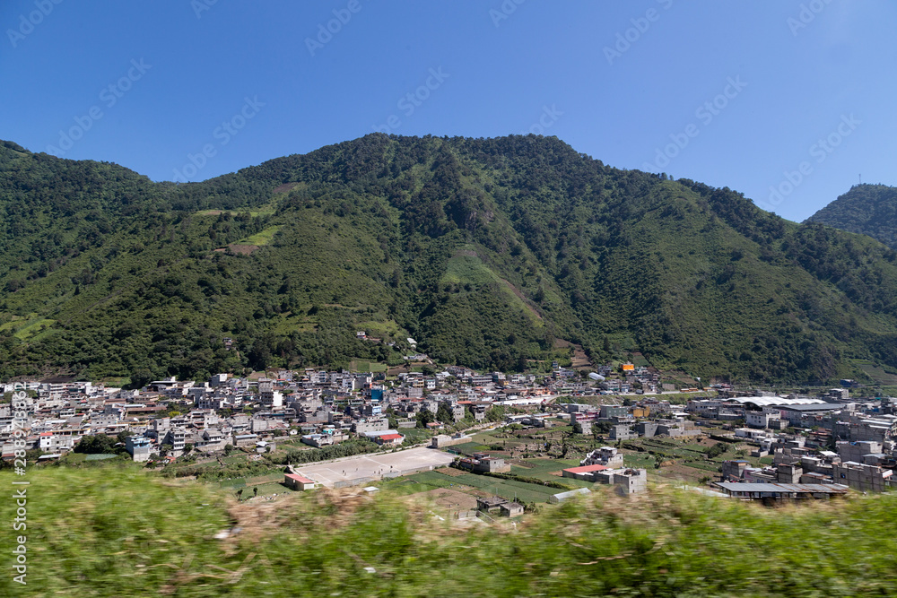 panoramic of small town surrounded by mountains - landscape of latino america Guatemala