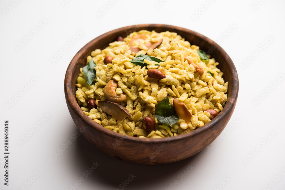 Jada Poha Namkeen Chivda / Thick Pohe Chiwda is a jar snack with a mix of sweet, salty and nuts flavours, served with tea. selective focus Jada Poha Namkeen Chivda / Thick Pohe Chiwda is a jar snack with a mix of sweet, salty and nuts flavours, served with tea. selective focus