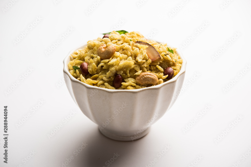 Jada Poha Namkeen Chivda / Thick Pohe Chiwda is a jar snack with a mix of sweet, salty and nuts flavours, served with tea. selective focus Jada Poha Namkeen Chivda / Thick Pohe Chiwda is a jar snack with a mix of sweet, salty and nuts flavours, served with tea. selective focus