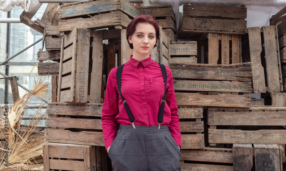 Girl in trousers and suspenders in stock Girl in trousers and suspenders in stock