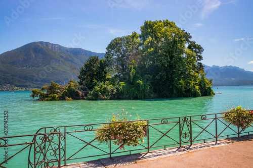 Iles des Cygnes, a famous artificial island on Lake Annecy with the French Alps in the background Annecy, France photo