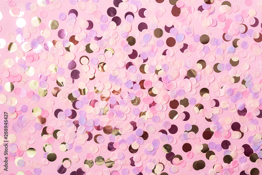Fototapeta premium Pastel pink background with colorful round paper confetti. Holiday concept. Flat lay.