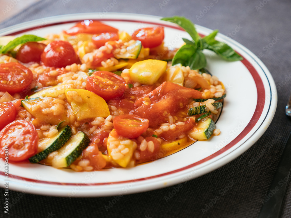 Plate with a home made zucchini and tomato risotto. Plate with a home made zucchini and tomato risotto.