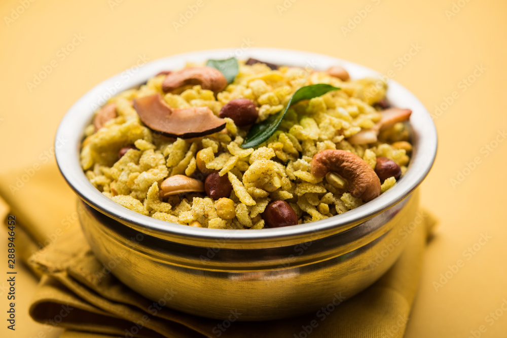 Jada Poha Namkeen Chivda / Thick Pohe Chiwda is a jar snack with a mix of sweet, salty and nuts flavours, served with tea. selective focus Jada Poha Namkeen Chivda / Thick Pohe Chiwda is a jar snack with a mix of sweet, salty and nuts flavours, served with tea. selective focus