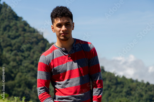 Portrait of Latino man in rural area with mountains behind in Guatemala