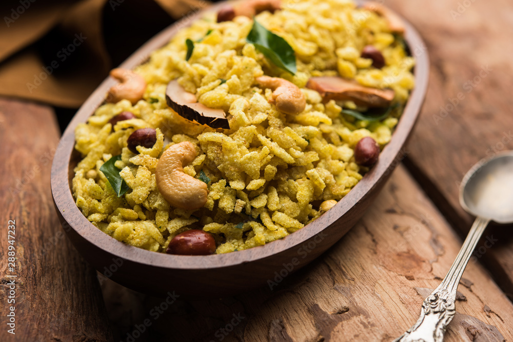 Jada Poha Namkeen Chivda / Thick Pohe Chiwda is a jar snack with a mix of sweet, salty and nuts flavours, served with tea. selective focus