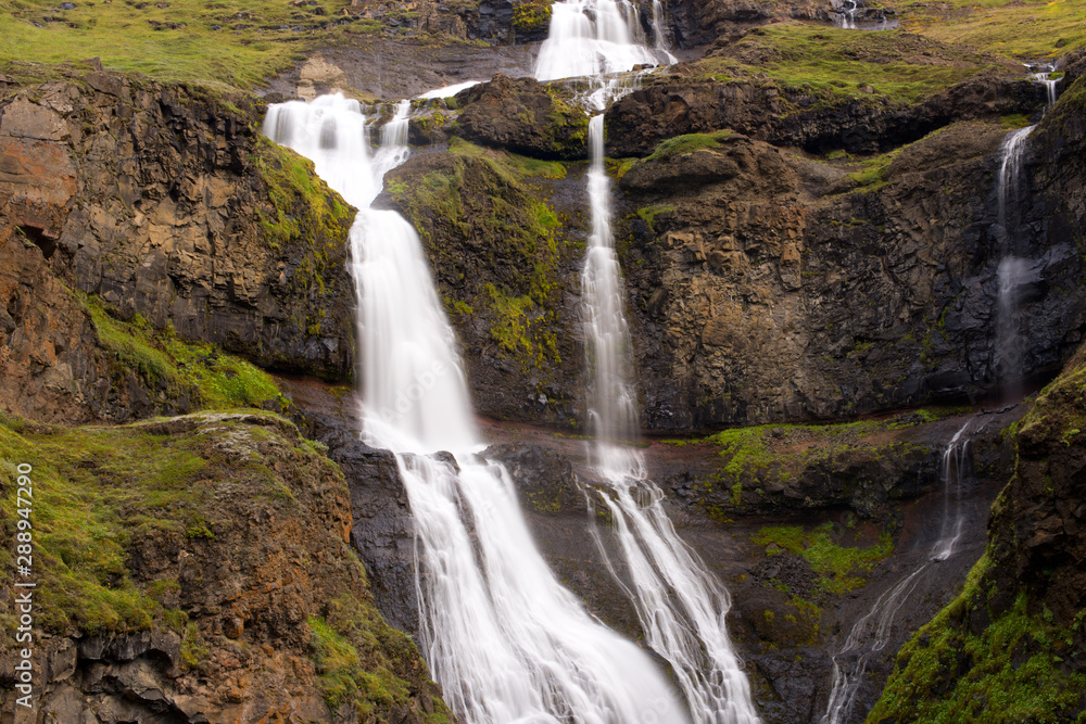 Long exposure photo of waterfall, view of the Hengifoss waterfall in Iceland, Europe. Long exposure photo of waterfall, view of the Hengifoss waterfall in Iceland, Europe.