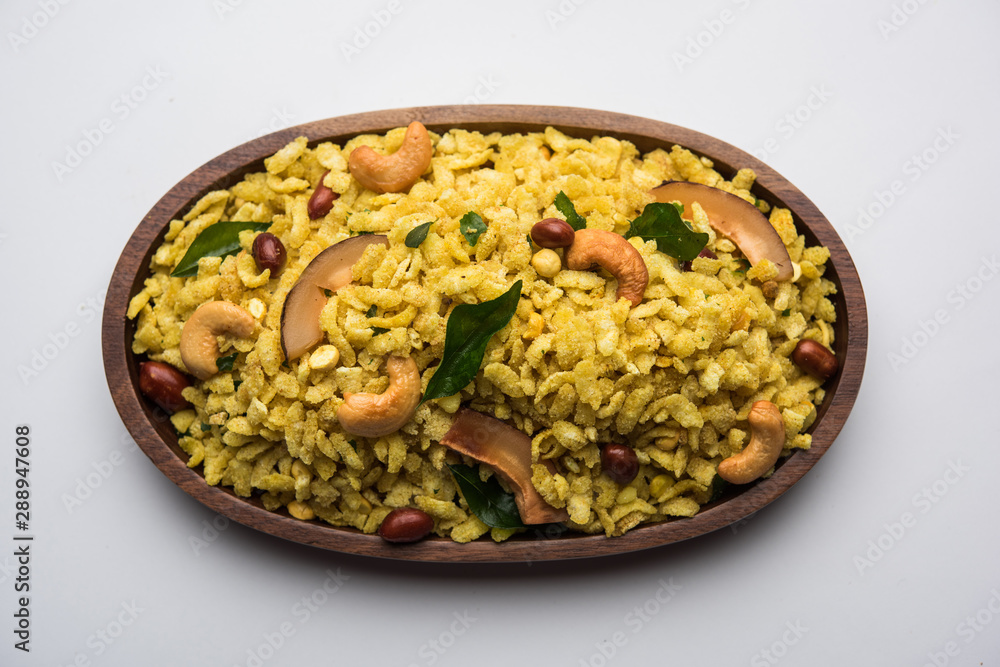 Jada Poha Namkeen Chivda / Thick Pohe Chiwda is a jar snack with a mix of sweet, salty and nuts flavours, served with tea. selective focus Jada Poha Namkeen Chivda / Thick Pohe Chiwda is a jar snack with a mix of sweet, salty and nuts flavours, served with tea. selective focus
