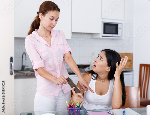 Mother taking away smartphone