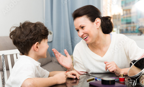 Cheerful woman telling story to son