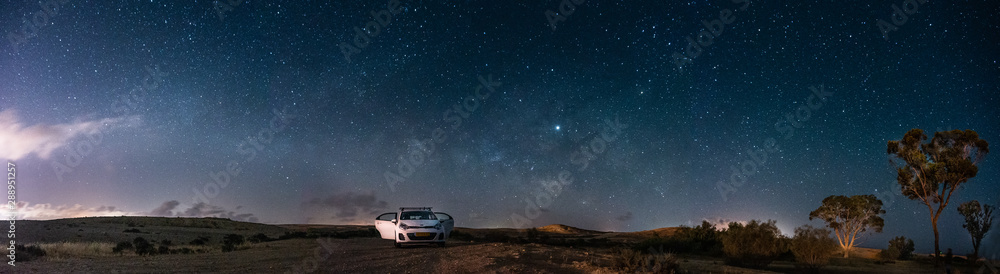 Milky way Panorama and white car in a park Milky way Panorama and white car in a park