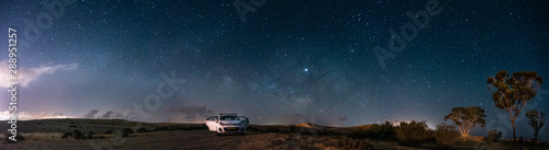 Milky way Panorama and white car in a park