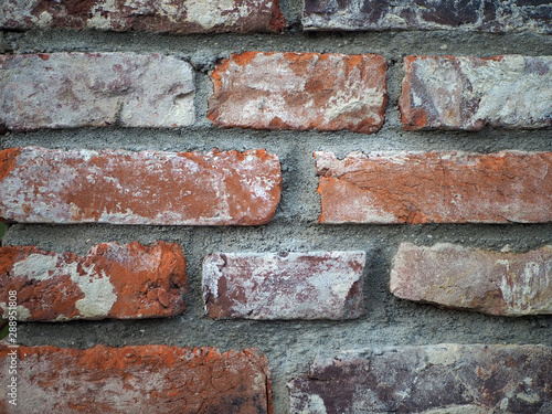 Old red brick wall background, close up