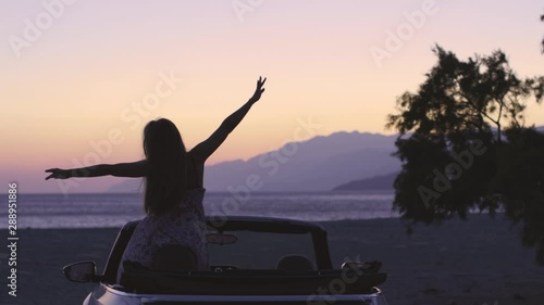 Young Woman in Cabriolet at Sunset