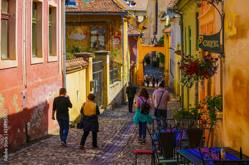 Sighisoara, Romania, May 14, 2019: Beautiful colorful street in Sighisoara in typical traditional style.