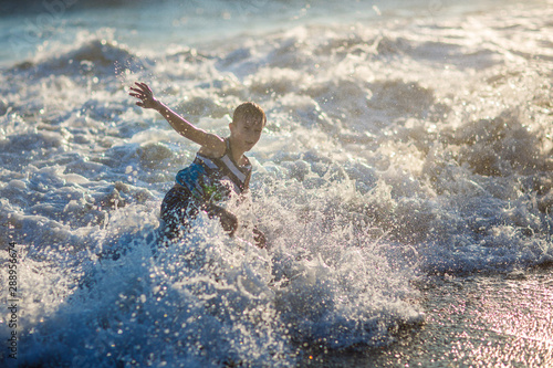 boy playing on the waves