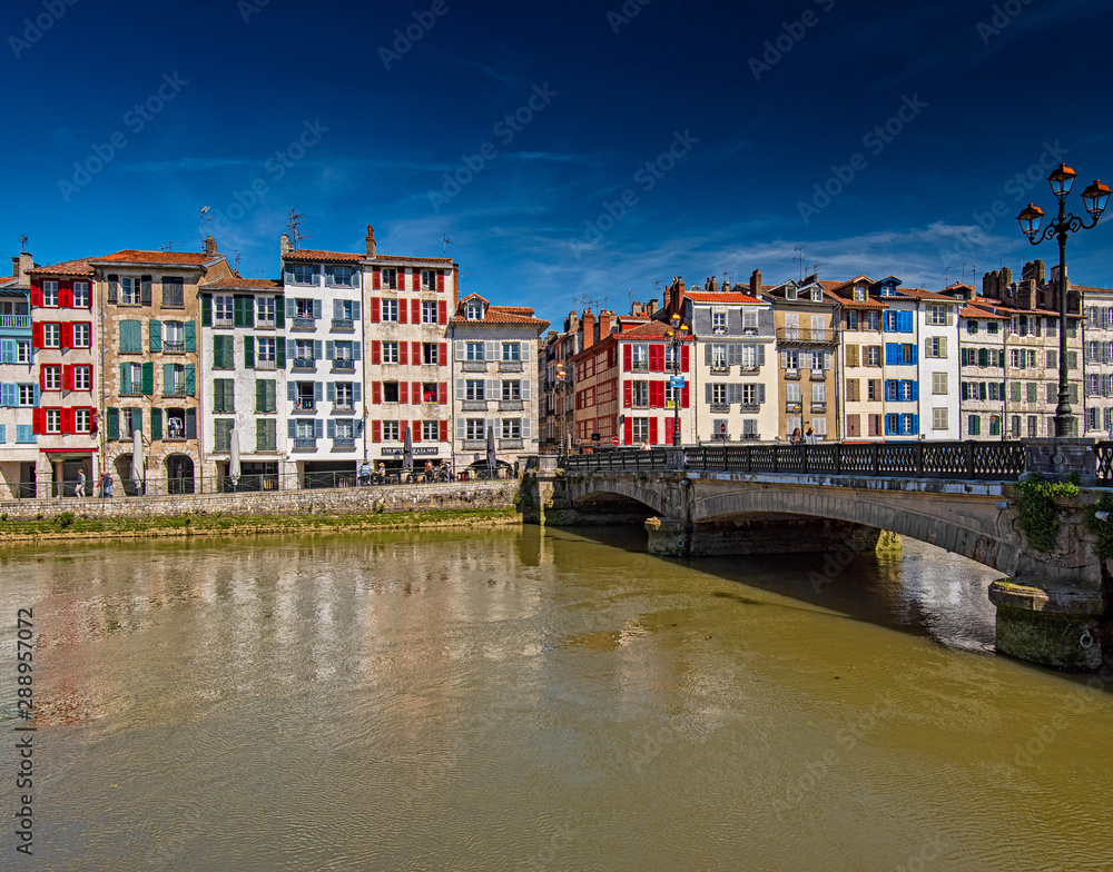 Colorful houses at the Nive river embankment in Bayonne, France Colorful houses at the Nive river embankment in Bayonne, France