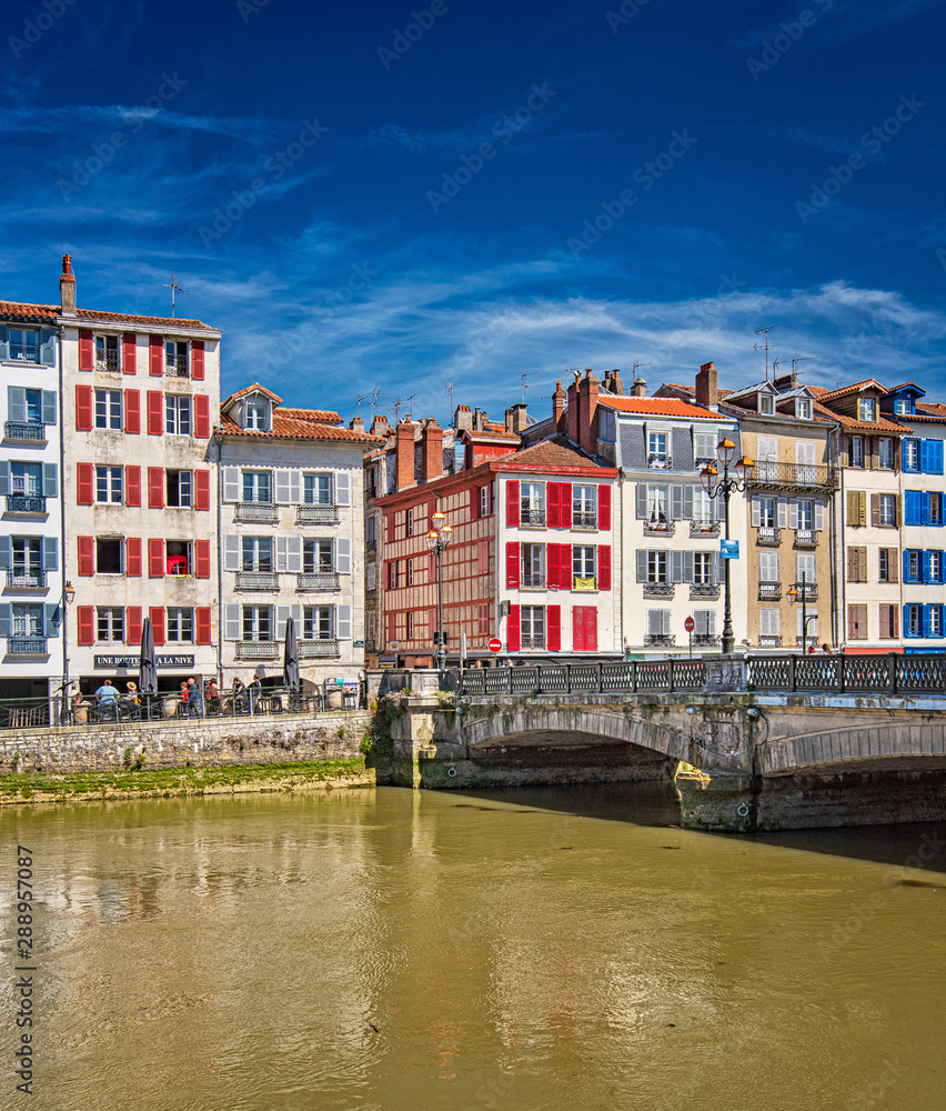 Colorful houses at the Nive river embankment in Bayonne, France