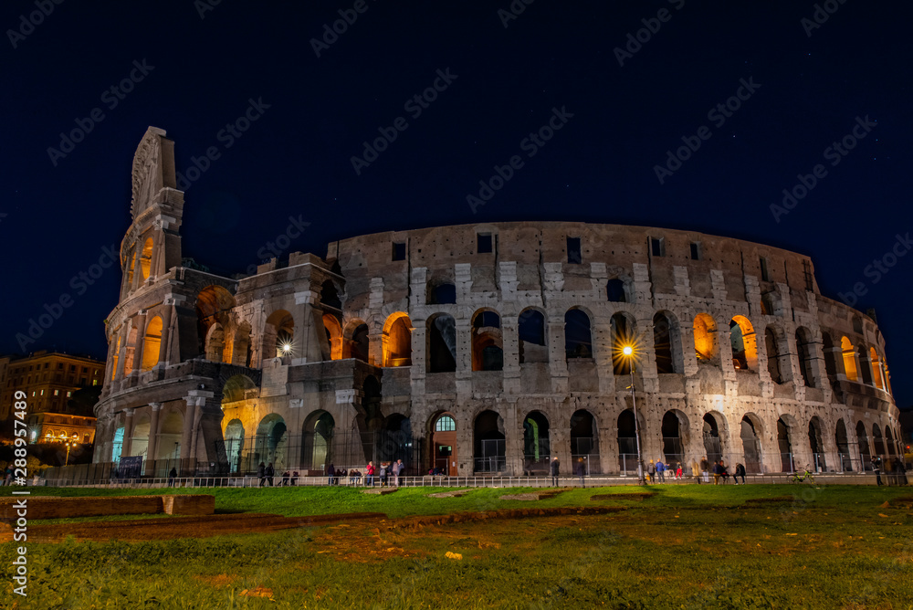 Colosseum at night with people