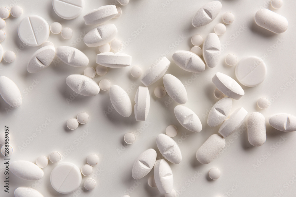 White pills on white background. Flat lay. White pills on white background. Flat lay.