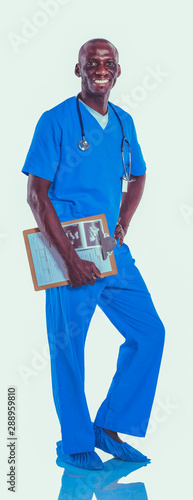 Male doctor standing with folder, isolated on white background. Doctor. Clinic.