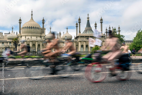 blurred naked cyclists going past brighton pavillion