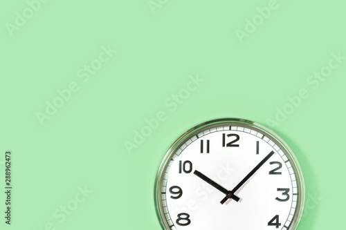 Obraz na plátně Part of analogue plain wall clock on trendy pastel mint background