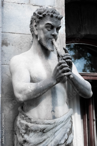 The sculpture of Pan with a flute at the wall of Massandra Palace photo