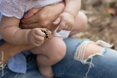 eet newborn in the arms of the mother. feet of a newborn baby. little foot photo