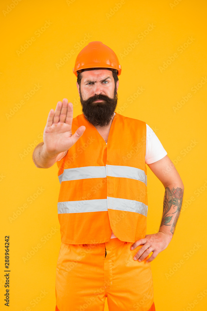 Be careful, under construction. Man worker warning about under construction area. Hard worker showing caution hand gesture. Mining area under construction. Under construction