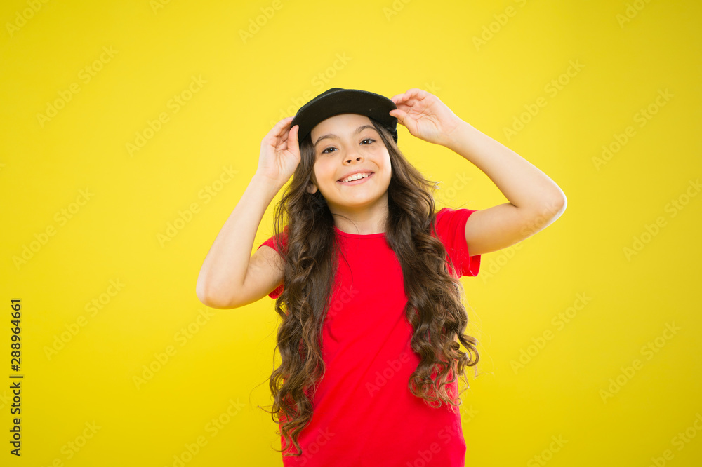 Compete for Your Street. hipster child at yellow wall. happy childhood. beauty and fashion. small girl with long hair. cool girl with long curly hair. kid fashion. happy girl in trendy hipster cap Compete for Your Street. hipster child at yellow wall. happy childhood. beauty and fashion. small girl with long hair. cool girl with long curly hair. kid fashion. happy girl in trendy hipster cap