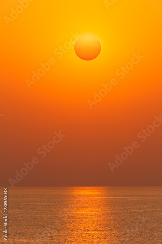 Fototapeta Naklejka Na Ścianę i Meble -  Sun disk on sunset over of the sea horizon
