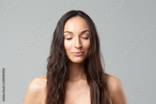 Young beautiful woman with clean perfect skin close-up.